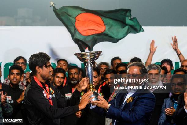 Bangladesh's Cricket Board President Nazmul Hasan Papon and Bangladesh's Under-19 cricket team captain Akbar Ali hold the International Cricket...