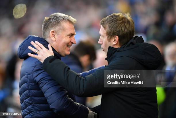 Dean Smith, Manager of Aston Villa shakes hands with Graham Potter, Manager of Brighton & Hove Albion during the Premier League match between...