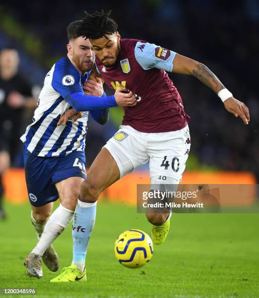 Aaron Connolly of Brighton & Hove Albion challenges Tyrone Mings of Aston Villa during the Premier League match between Brighton & Hove Albion and...