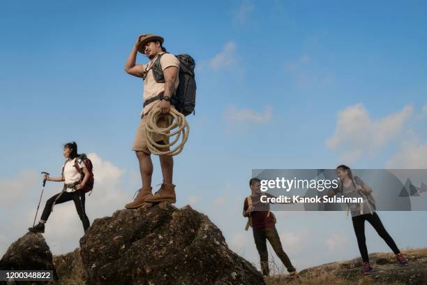 shot of group of people hiking through the mountain - fashion range stock pictures, royalty-free photos & images