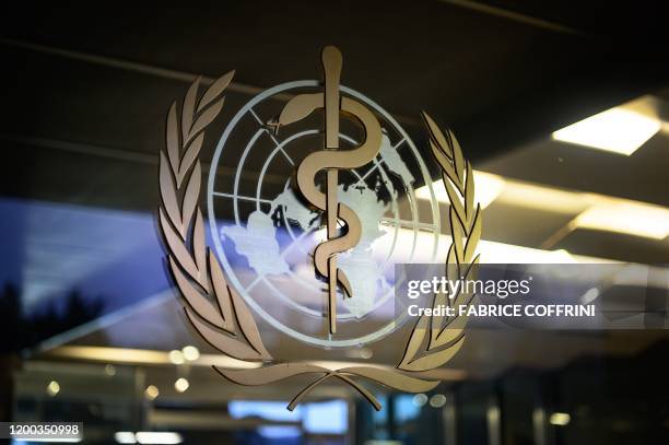 Picture taken on January 12, 2020 shows a World Health Organization sign at its headquarters prior to a combined news conference following a two-day...