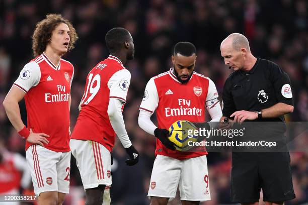 Referee Mike Dean speaks with Alexandre Lacazette of Arsenal during the Premier League match between Arsenal FC and Sheffield United at Emirates...