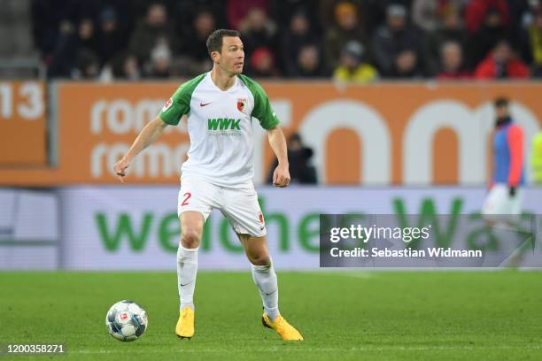 Stephan Lichtsteiner of FC Augsburg plays the ball during the Bundesliga match between FC Augsburg and Borussia Dortmund at WWK-Arena on January 18,...