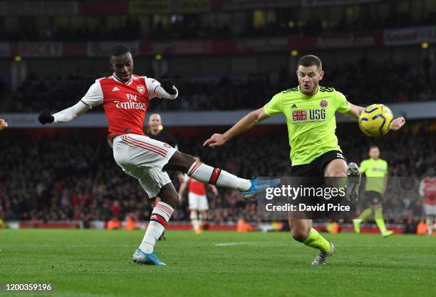 Eddie Nketiah of Arsenal shoots under pressure from Jack O'Connell of Shef Utd during the Premier League match between Arsenal FC and Sheffield...