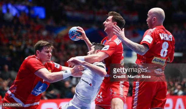 Raúl Entrerríos of Spain is challenged by Daniel Dicker, Lukas Herburger and Robert Weber of Austria during the Men's EHF EURO 2020 main round group...