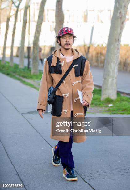 Guest is seen wearing brown coat outside Loewe during Paris Fashion Week - Menswear F/W 2020-2021 on January 18, 2020 in Paris, France.