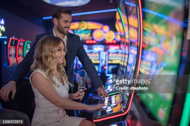 couple having fun and drinking wine at casino - casino stock pictures, royalty-free photos & images