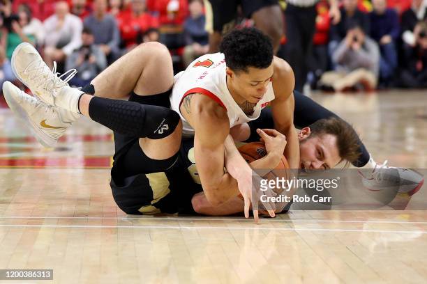 Anthony Cowan Jr. #1 of the Maryland Terrapins fouls Sasha Stefanovic of the Purdue Boilermakers while going after a loose ball in the second half at...