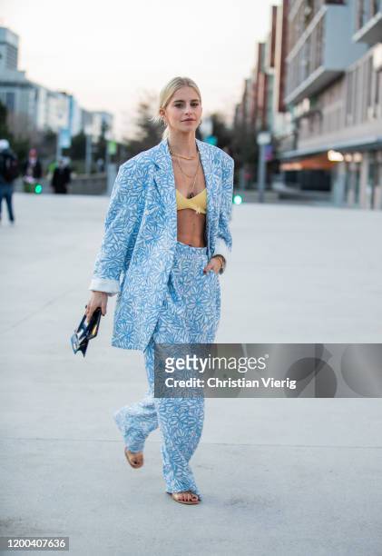 Caroline Caro Daur seen wearing blue blazer and pants with graphic print, yellow bra, black mini bag outside Jacquemus during Paris Fashion Week -...