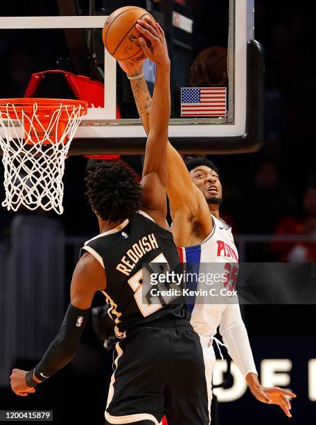 Christian Wood of the Detroit Pistons blocks a dunk attempt by Cam Reddish of the Atlanta Hawks in the first half at State Farm Arena on January 18,...