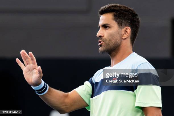 Maximo Gonzalez of Argentina hits a backhand in the men's doubles grand final with partner Fabrice Martin of France against Ivan Dodig of Croatia and...