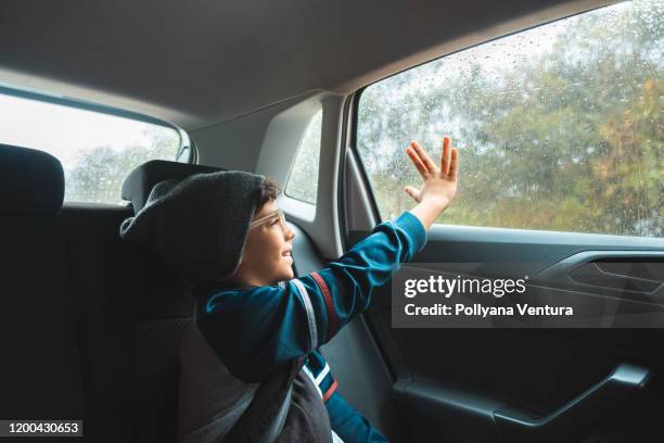 car trip in the rain - kids inside car stock pictures, royalty-free photos & images