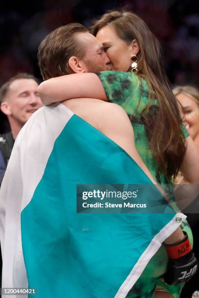 Conor McGregor kisses Dee Devlin after his first round TKO victory against Donald Cerrone in a welterweight bout during UFC246 at T-Mobile Arena on...