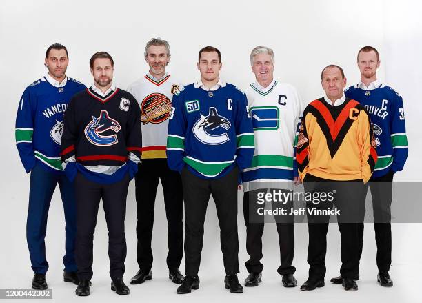 Roberto Luongo, Markus Naslund, Trevor Linden, Bo Horvat, Orland Kurtenbach, Stan Smyl, and Henrik Sedin pose for a photo before the NHL game between...