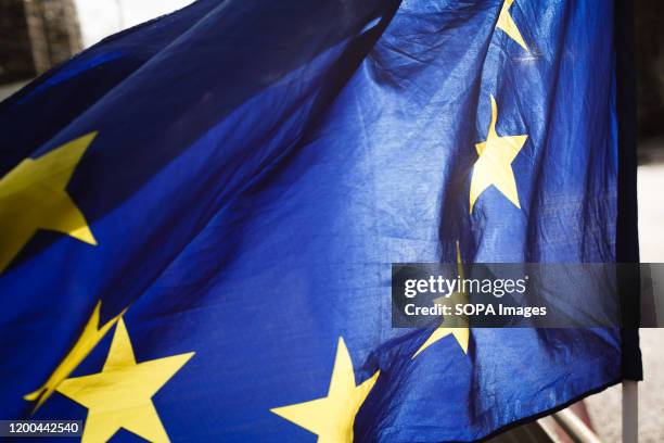 An EU flag flies as anti-Brexit activists demonstrate outside the Houses of Parliament in London.