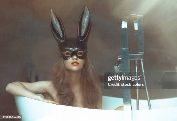 blonde girl wearing bunny mask in the... bathtub?! - rabbit mask stock pictures, royalty-free photos & images