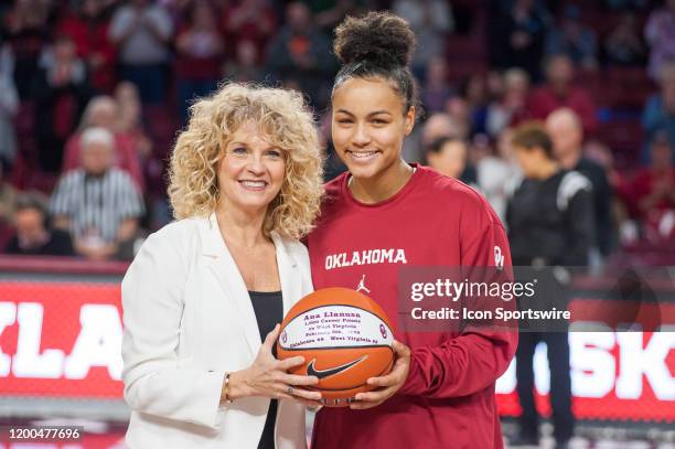 Oklahoma coach Sherri Coale and Oklahoma Ana Llanusa in recognition of scoring her 100th point as an OU Sooner on February 11 at the Lloyd Noble...