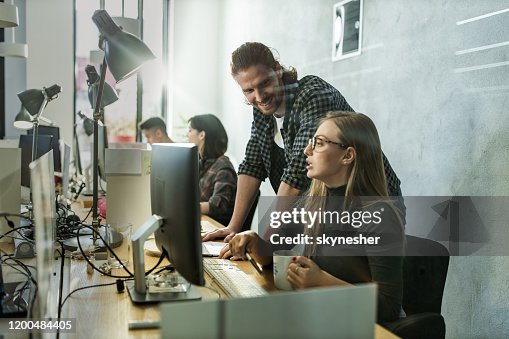 Young Happy Programmers Cooperating While Working On Desktop Pc In The ...