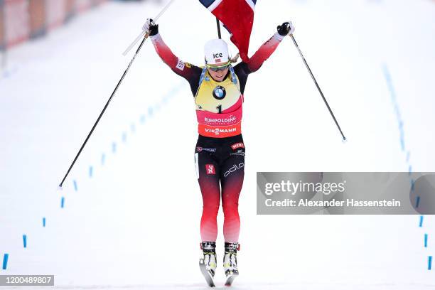 Tiril Eckhoff of Norway jumps over the finish line in celebration of winning the Women 10 km Pursuit Competition at the BMW IBU World Cup Biathlon...