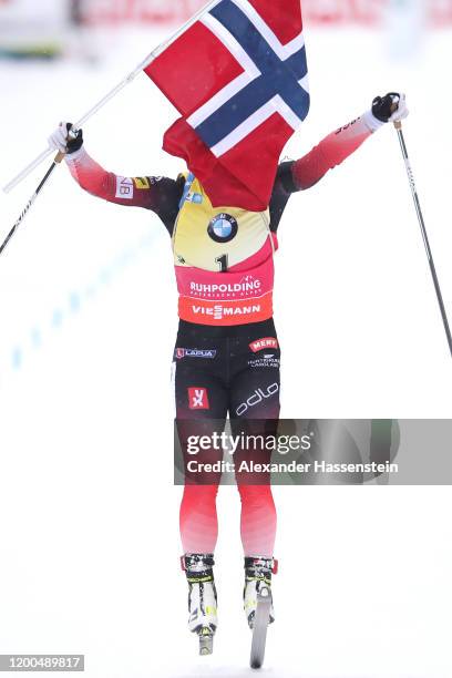 Tiril Eckhoff of Norway jumps over the finish line in celebration of winning the Women 10 km Pursuit Competition at the BMW IBU World Cup Biathlon...