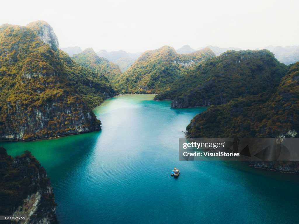 Aerial view of sunset above group of small tropical islands in the turquoise sea in Vietnam