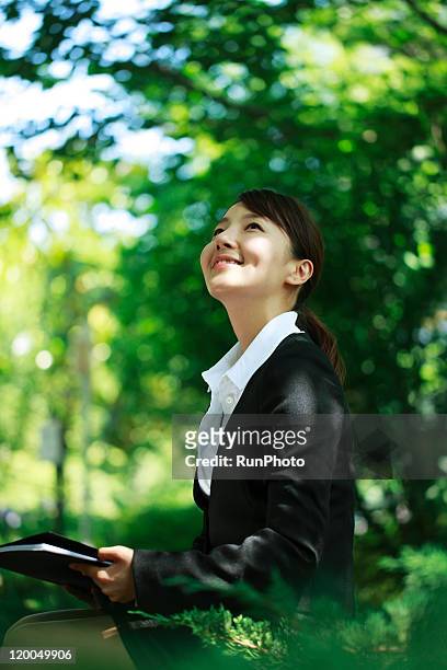young business woman - japanese woman looking up stockfoto's en -beelden