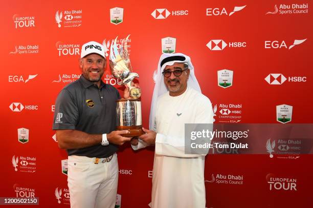 Lee Westwood of England poses with the trophy and Abdulfattah Sharaf, CEO of HSBC in the UAE after winning the Abu Dhabi HSBC Championship following...