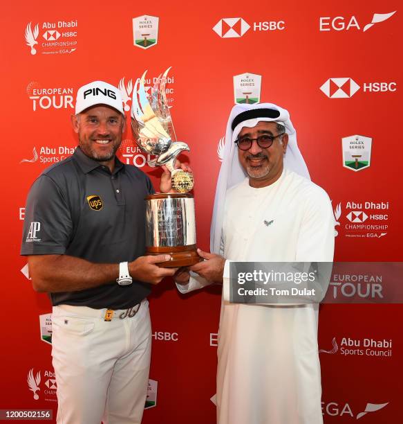 Lee Westwood of England poses with the trophy and Abdulfattah Sharaf, CEO of HSBC in the UAE after winning the Abu Dhabi HSBC Championship following...