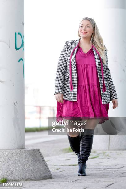 German presenter, curvy model and plus size influencer wearing a pink dress by Reserved and white checked blazer by Riana during a street style...