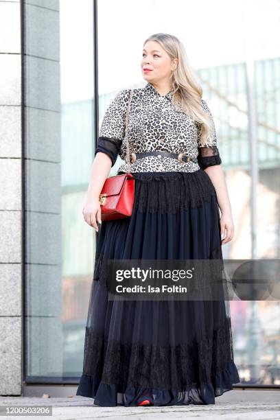 German presenter, curvy model and plus size influencer wearing a black dress with ruffles, a jacket in leopard look by Marina Rinaldi, a red Gucci...