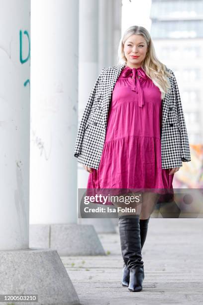 German presenter, curvy model and plus size influencer wearing a pink dress by Reserved and white checked blazer by Riana during a street style...