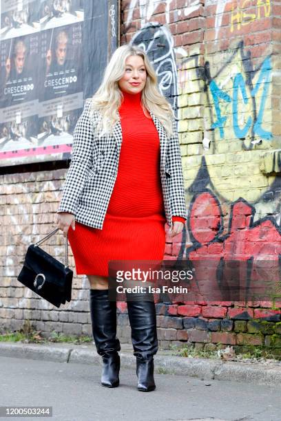 German presenter, curvy model and plus size influencer wearing a red pullover and a red skirt with a black and white checked blazer by Riani, black...