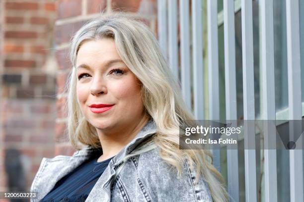 German presenter, curvy model and plus size influencer wearing a dark blue dress with ruffles and a jeans jacket by Marina Rinaldi during a street...