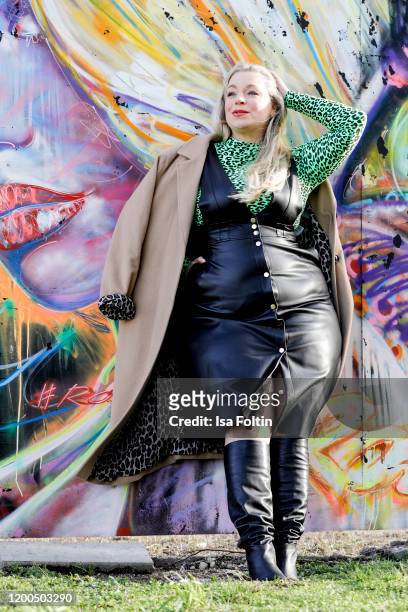 German presenter, curvy model and plus size influencer wearing a green tiger look dress by Zara and a black dress in leather look by C&A, a beige...
