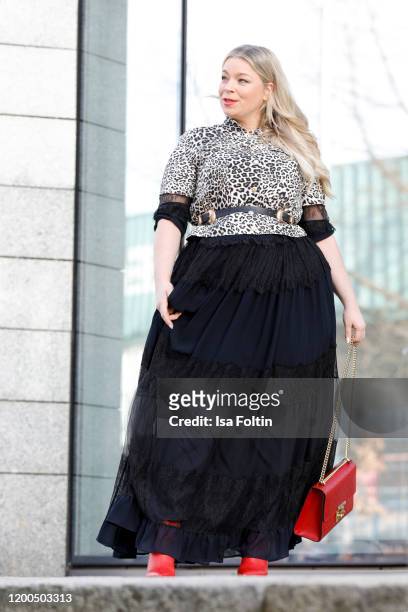 German presenter, curvy model and plus size influencer wearing a black dress with ruffles, a jacket in leopard look by Marina Rinaldi, a red Gucci...