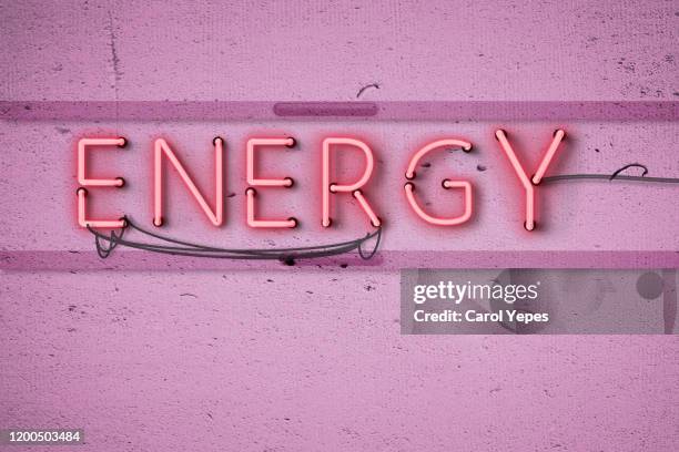 energy text in neon light - rock font stock pictures, royalty-free photos & images