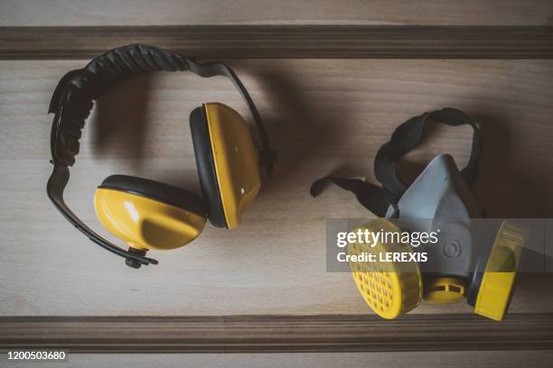 protective mask and ear protection headphones - respiratory protection construction stock pictures, royalty-free photos & images
