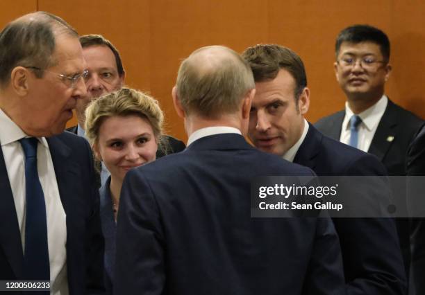 Russian President Vladimir Putin , Russian Foreign Minister Sergey Lavrov and French President Emmanuel Macron attend the main session at an...