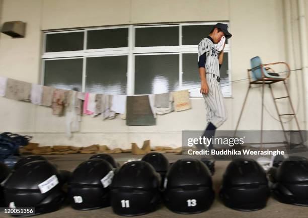 Baseball player weeps and walks over the gears after their team didn't qualify in the national tournament during the High School Baseball Tournament...