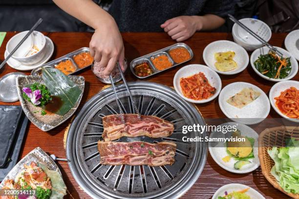 korean barbecue and side dishes - korean culture stock pictures, royalty-free photos & images