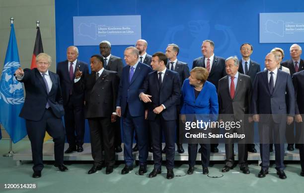 British Prime Minister Boris Johnson gestures as other participants, including German Chancellor Angela Merkel, French President Emmanuel Macron,...