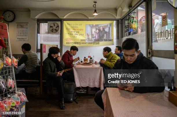 Customers sit in the 'Sky Pizza' restaurant in Seoul on February 13, 2020. - Locations featured in the South Korea's Oscar-winning "Parasite" are...