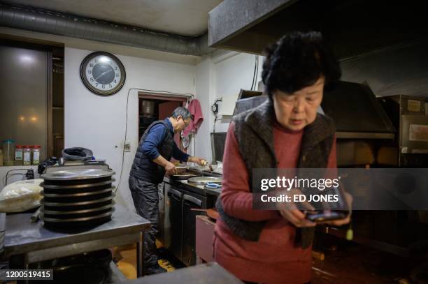 Pizza restaurant owner Eom Hang-ki works in her restaurant 'Sky Pizza' in Seoul on February 13, 2020. - Locations featured in the South Korea's...
