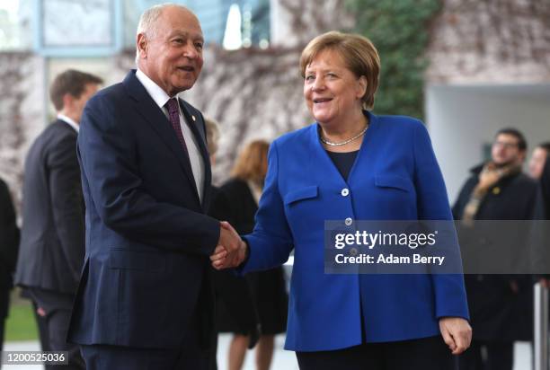 German Chancellor Angela Merkel greets Arab League Secretary-General Ahmed Aboul Gheit as he arrives for an international summit on securing peace in...