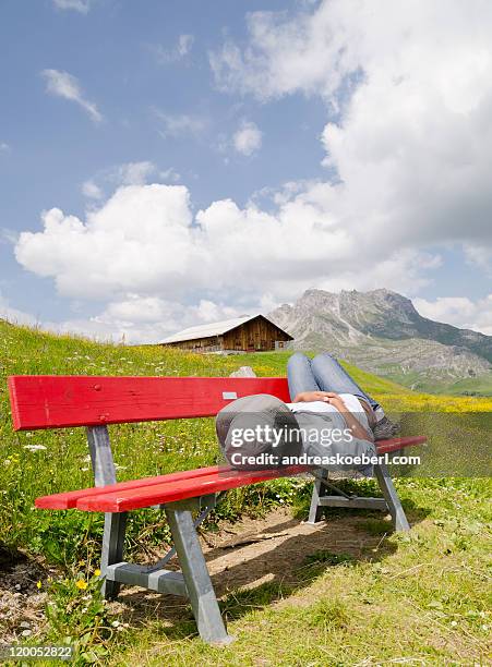 bench in  alps with girl and mountains - andreaskoeberl stock-fotos und bilder