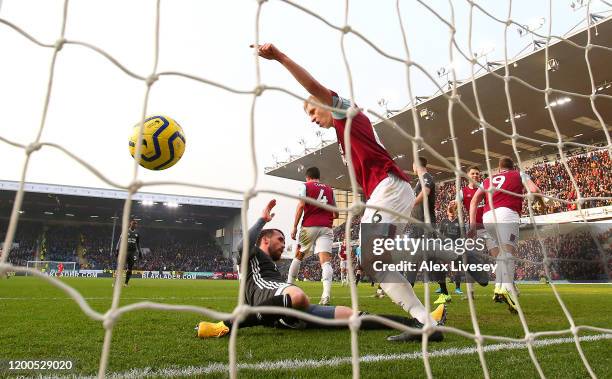 Chris Wood of Burnley celebrates after scoring his team's first goal as Christian Fuchs of Leicester City reacts during the Premier League match...