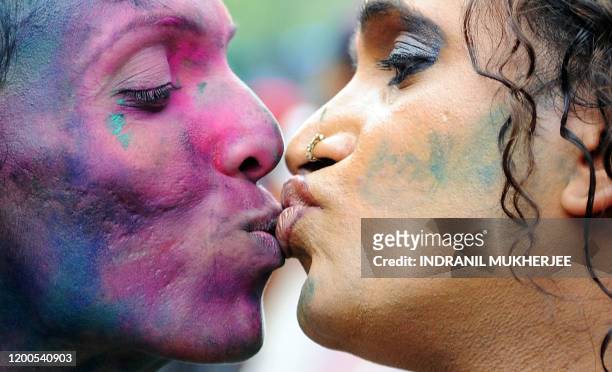 Eunuch Laksmi kisses another member of the transgender, gay and lesbian communities as they celebrate an Indian court's ruling decriminalising gay...