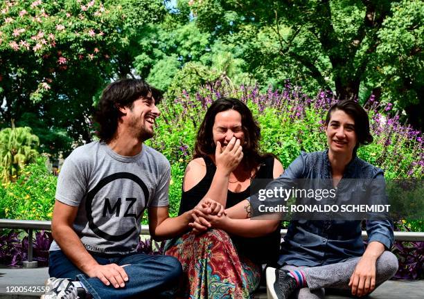 Gabriel Lopez, May Ferreira and Deb Barreiro, pose for a picture at Pueyrredon park, in Buenos Aires, on February 11, 2020. - "Polyamory" and other...