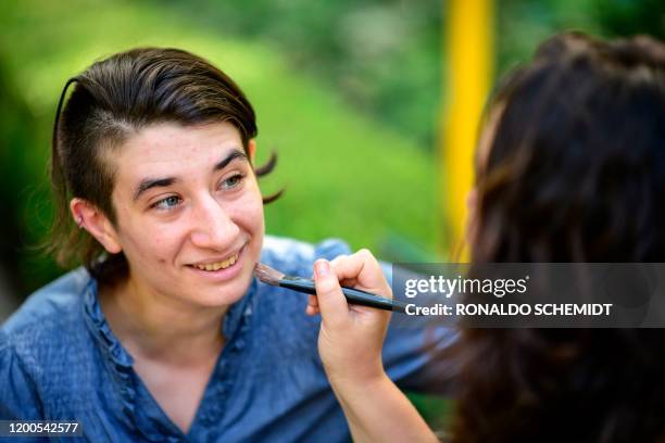 May Ferreira makes up Deb Barreiro at Pueyrredon park, in Buenos Aires, on February 11, 2020. - "Polyamory" and other ways to conceive...