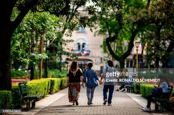 May Ferreira, Deb Barreiro and Gabriel Lopez walk at Pueyrredon park, in Buenos Aires, on February 11, 2020. - "Polyamory" and other ways to conceive...